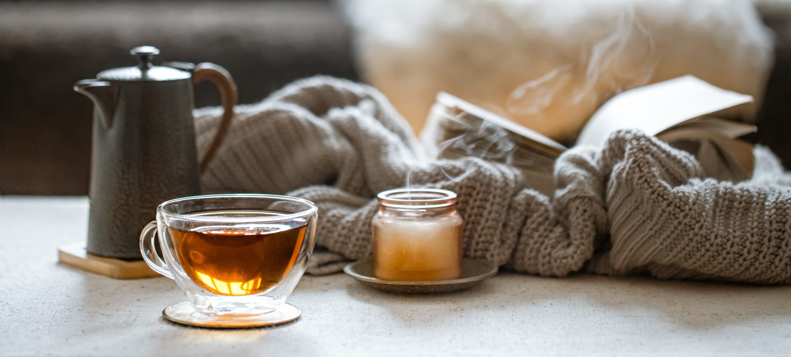 glass cup tea teapot candle with knitted element concept home comfort warmth 1 scaled