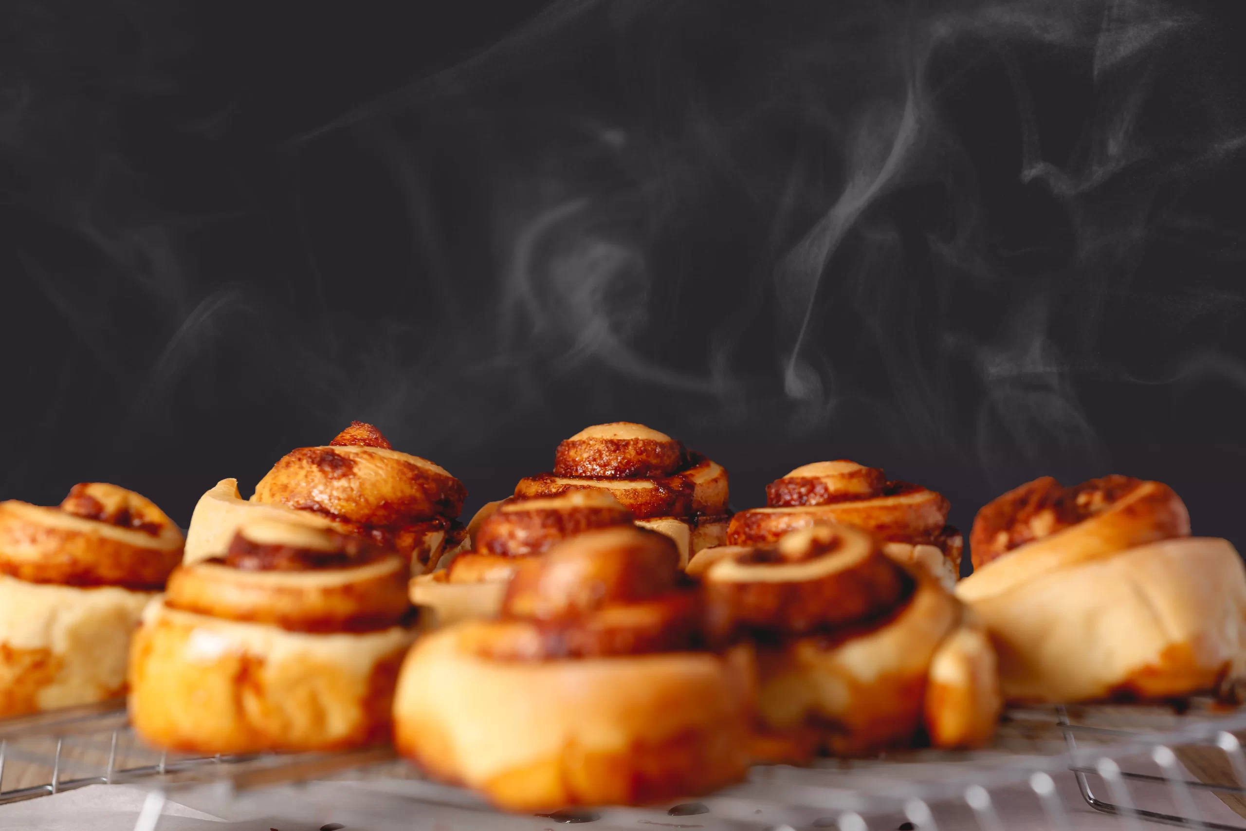 vertical shot hot delicious cinnabons table black background 1 edited scaled