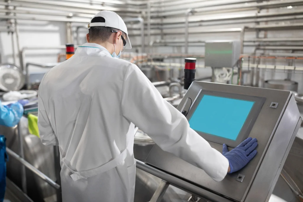 concentrated technologist taking necessary notes with help digital tablet while standing production 1 1