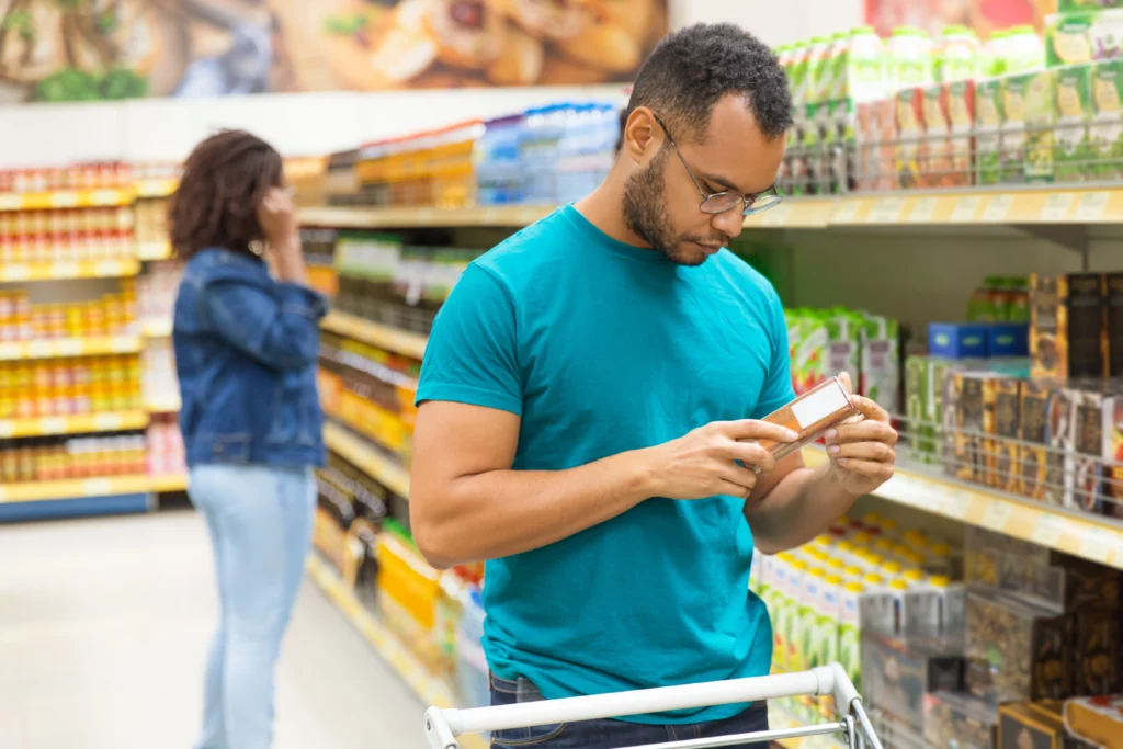 focused african american man reading information packaging